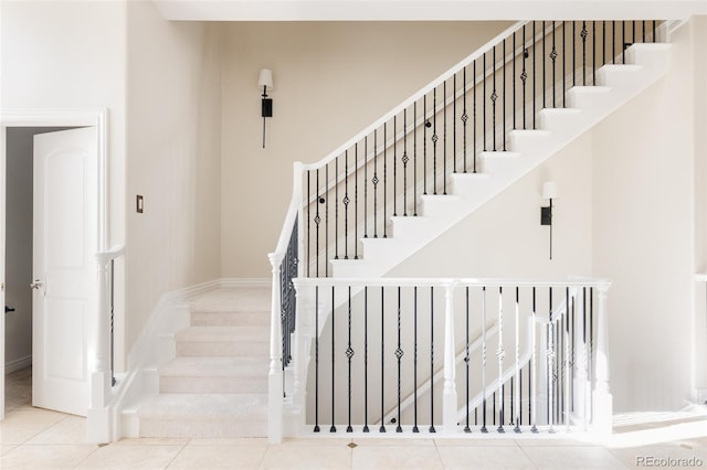 stairway with tile patterned floors