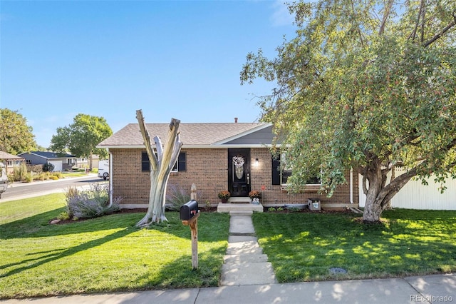 view of front of home featuring a front lawn and brick siding