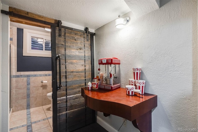 full bathroom featuring a textured wall, toilet, tile patterned floors, walk in shower, and a textured ceiling