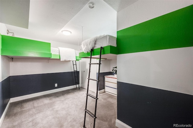 bedroom featuring carpet, a textured ceiling, and baseboards