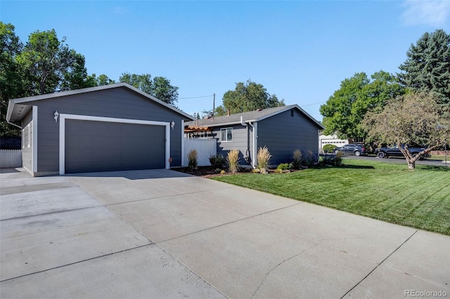 single story home with a garage, fence, an outbuilding, and a front yard