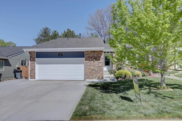 8745 W Ottawa Ave, Littleton, CO 80128 - view of front of property with brick siding, concrete driveway, and a front lawn