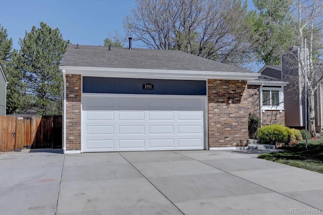 8745 W Ottawa Ave, Littleton, CO 80128 - view of front facade with brick siding, driveway, and roof with shingles