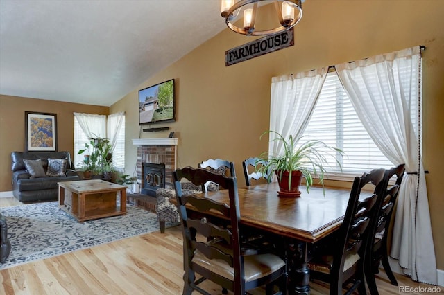 8745 W Ottawa Ave, Littleton, CO 80128 - dining room with vaulted ceiling, a chandelier, and wood finished floors