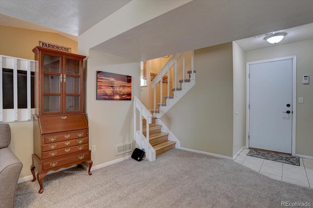 8745 W Ottawa Ave, Littleton, CO 80128 - foyer featuring light carpet, baseboards, and stairway