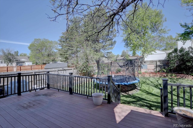8745 W Ottawa Ave, Littleton, CO 80128 - wooden deck with a trampoline