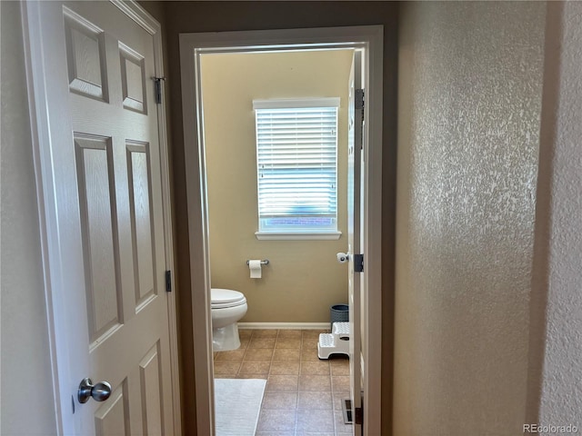 bathroom featuring tile patterned floors and toilet