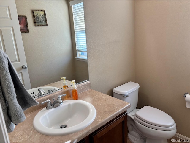 bathroom featuring vanity and toilet