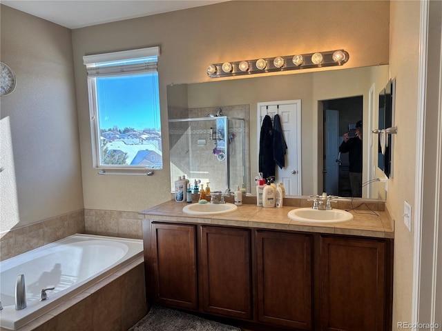 bathroom with vanity and separate shower and tub