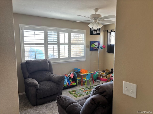 playroom with carpet floors and ceiling fan