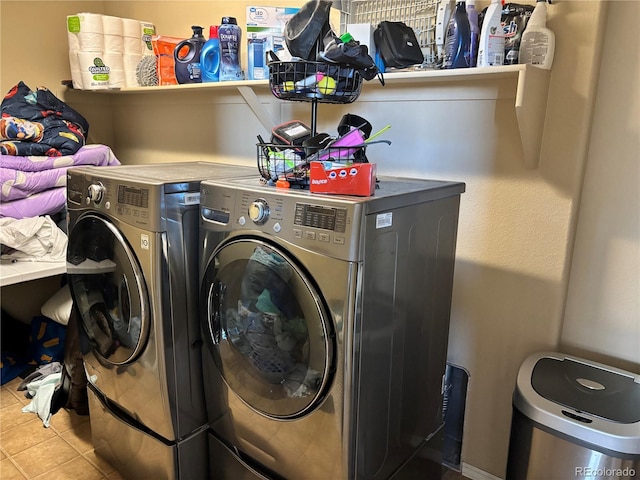 clothes washing area with tile patterned flooring and washer and clothes dryer