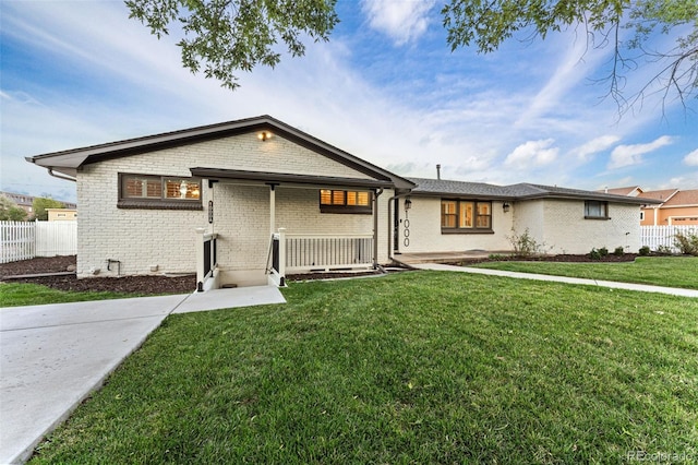 single story home with a porch and a front lawn