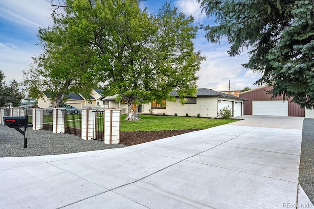 view of front of property with a garage and a front lawn