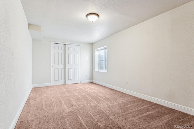 unfurnished bedroom featuring a closet and carpet