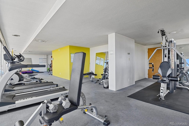 exercise room featuring a textured ceiling