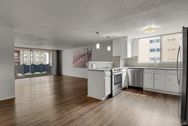 kitchen with stainless steel appliances, plenty of natural light, and white cabinets