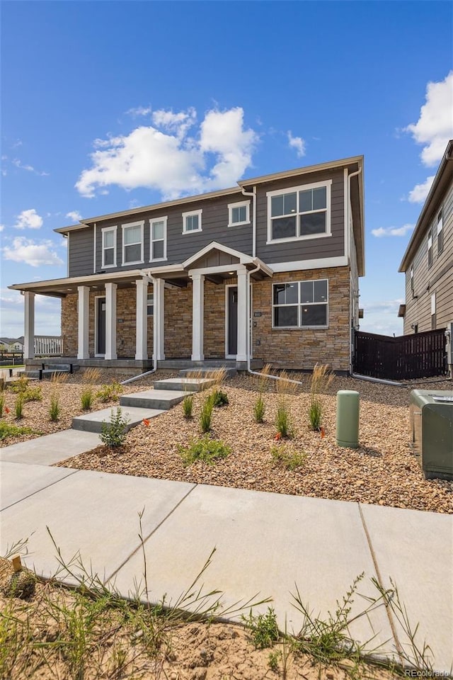 view of front of home featuring a porch and stone siding