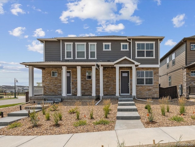 view of front of property featuring a porch and stone siding