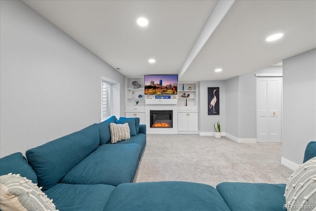 2153 Mountain Iris Dr, Erie, CO 80516 - living room featuring carpet, recessed lighting, a glass covered fireplace, baseboards, and built in shelves