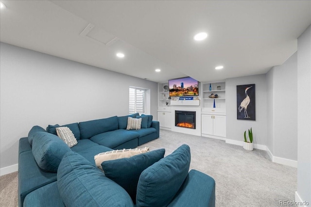 2153 Mountain Iris Dr, Erie, CO 80516 - living room featuring light carpet, baseboards, recessed lighting, a glass covered fireplace, and attic access
