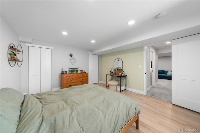 2153 Mountain Iris Dr, Erie, CO 80516 - bedroom with light wood finished floors, recessed lighting, and baseboards