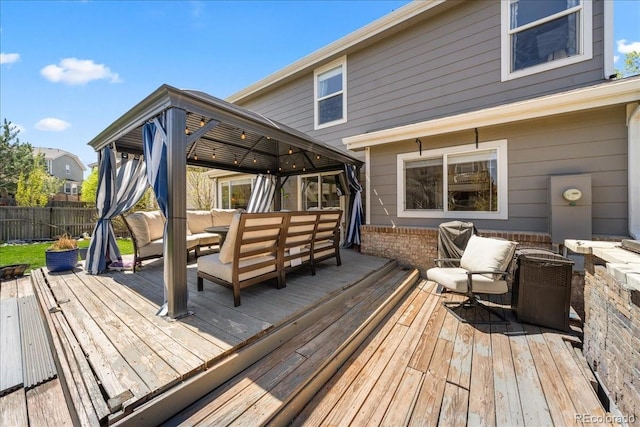 2153 Mountain Iris Dr, Erie, CO 80516 - wooden terrace featuring a gazebo, fence, an outdoor hangout area, and outdoor dining area