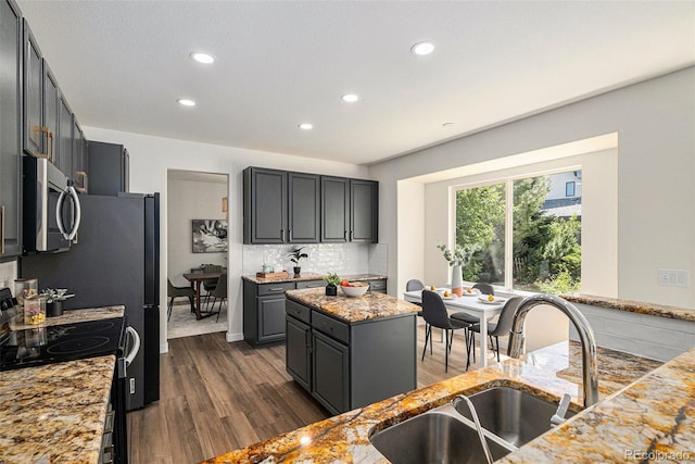 11868 W Progress Ave, Littleton, CO 80127 - kitchen with stainless steel microwave, range with electric stovetop, recessed lighting, dark wood-style flooring, and light stone counters