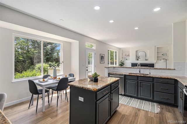 11868 W Progress Ave, Littleton, CO 80127 - kitchen featuring stainless steel dishwasher, healthy amount of natural light, light wood-style flooring, light stone counters, and recessed lighting