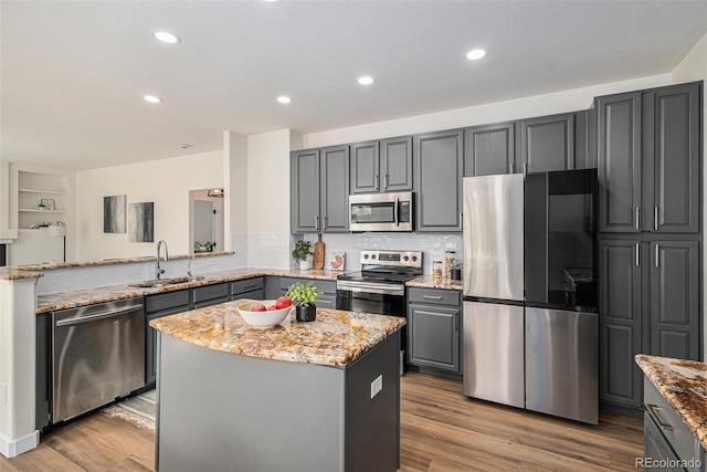 11868 W Progress Ave, Littleton, CO 80127 - kitchen with stainless steel appliances, gray cabinetry, light stone countertops, light wood-style floors, and recessed lighting