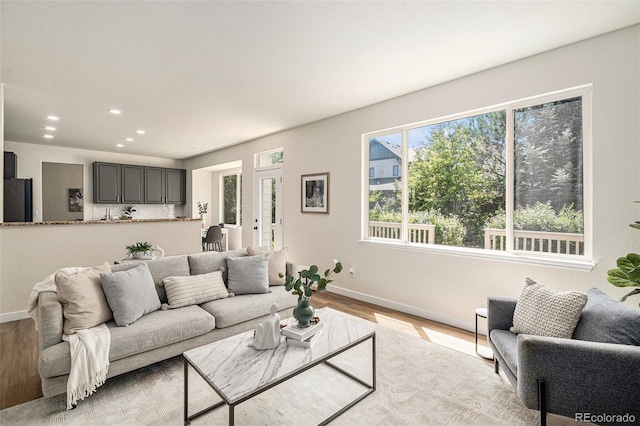 11868 W Progress Ave, Littleton, CO 80127 - living area featuring healthy amount of natural light, light wood-style flooring, recessed lighting, and french doors
