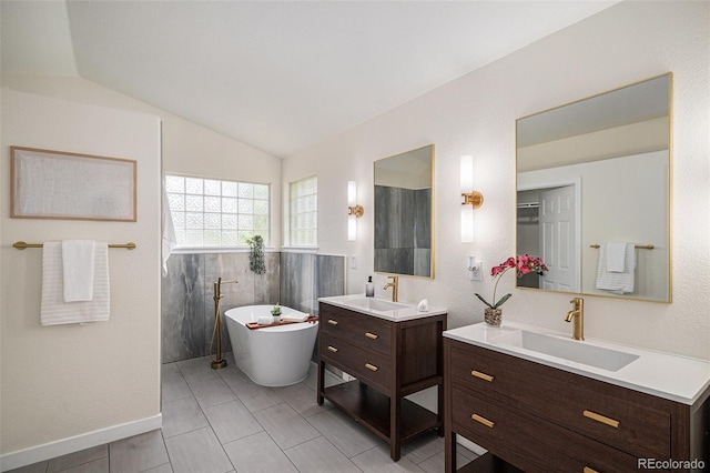 11868 W Progress Ave, Littleton, CO 80127 - full bath featuring two vanities, a soaking tub, and vaulted ceiling