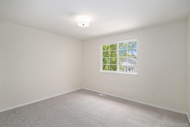 11868 W Progress Ave, Littleton, CO 80127 - spare room featuring baseboards and carpet