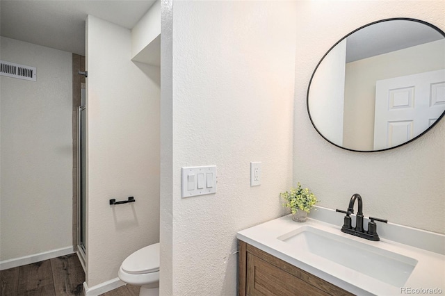 11868 W Progress Ave, Littleton, CO 80127 - bathroom featuring vanity, wood finished floors, and a shower with shower door