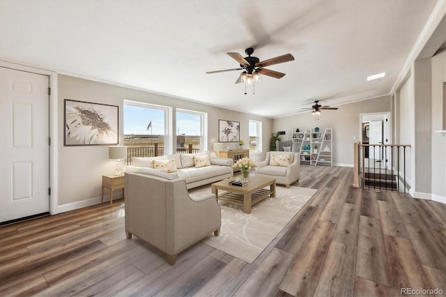 living room featuring hardwood / wood-style floors, crown molding, ceiling fan, and lofted ceiling