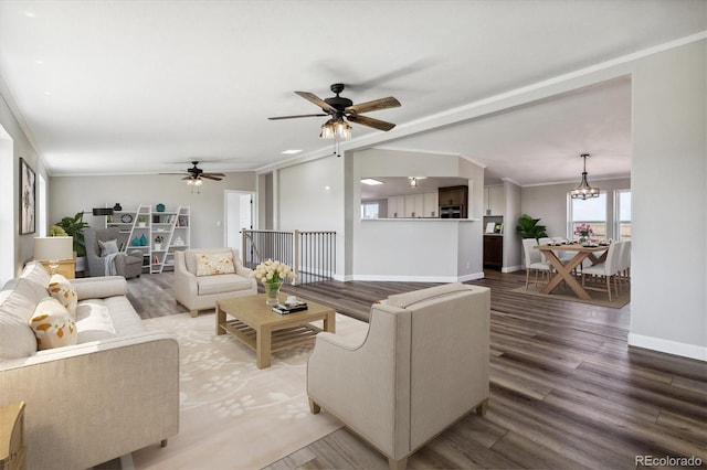 living room with hardwood / wood-style floors, ceiling fan with notable chandelier, and ornamental molding