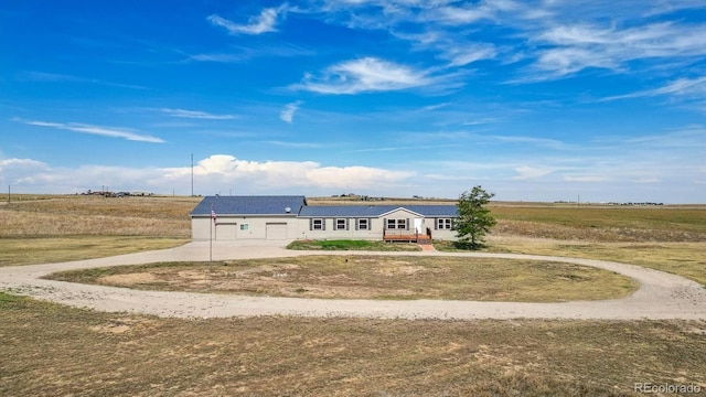 view of front of home with a rural view