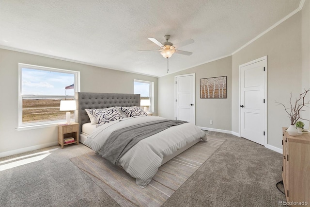 bedroom with carpet flooring, ceiling fan, ornamental molding, and a textured ceiling