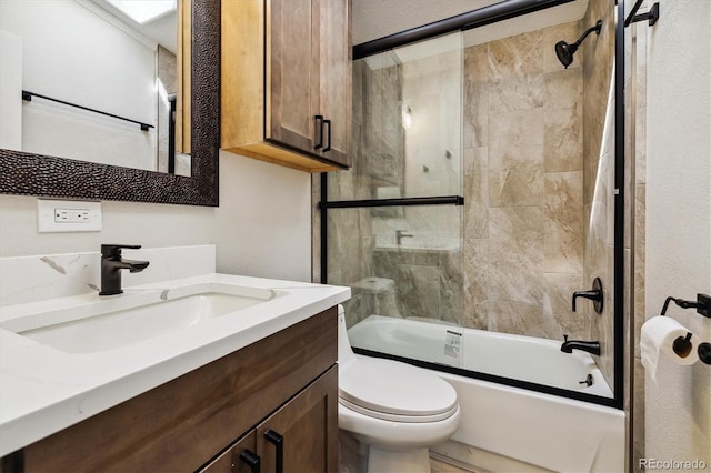 full bathroom with shower / bath combination with glass door, vanity, and toilet