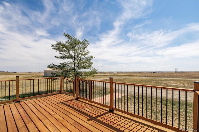 wooden terrace featuring a rural view