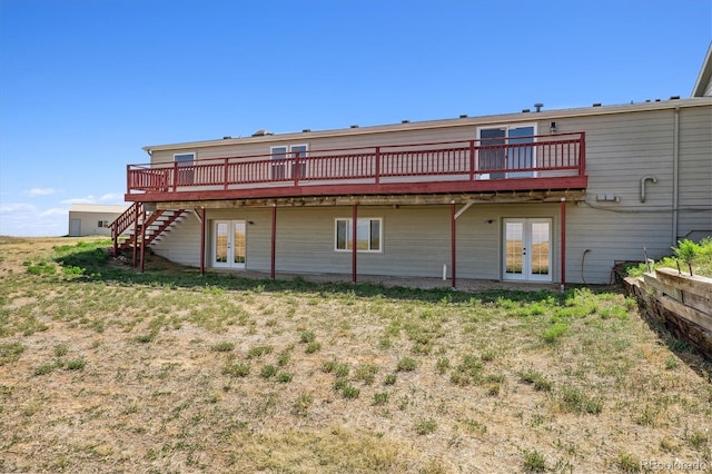 back of property featuring a deck and french doors