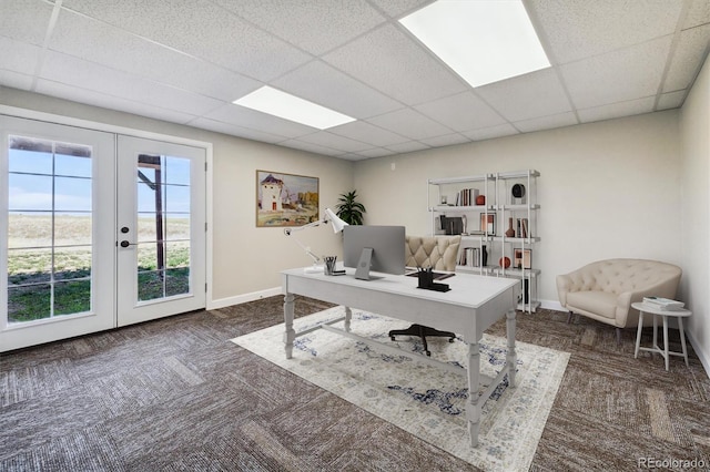 carpeted office space with french doors and a drop ceiling