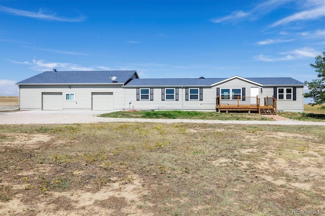 43343 E Arkansas Pl, Bennett, CO 80102 - back of property with a deck, a garage, and roof with shingles