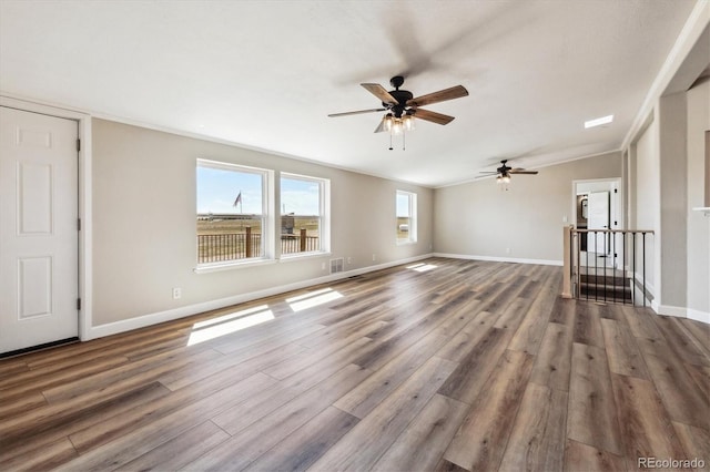 43343 E Arkansas Pl, Bennett, CO 80102 - unfurnished living room with a ceiling fan, wood finished floors, and baseboards