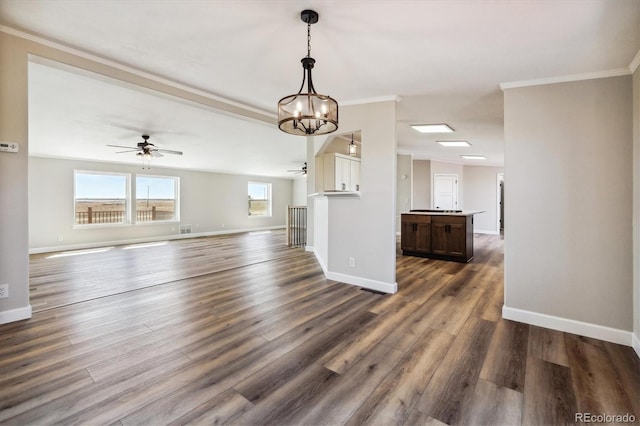 43343 E Arkansas Pl, Bennett, CO 80102 - unfurnished living room featuring ceiling fan, ornamental molding, baseboards, dark wood-style floors, and a chandelier