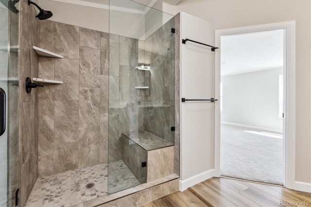 43343 E Arkansas Pl, Bennett, CO 80102 - full bath featuring crown molding, a stall shower, wood finished floors, and baseboards