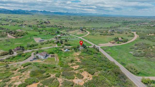 aerial view of property and surrounding area with a mountainous background and rural landscape