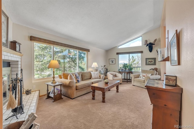 living area with carpet flooring, a glass covered fireplace, vaulted ceiling, a textured ceiling, and baseboards