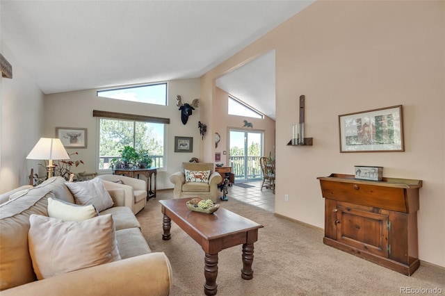 living area featuring light colored carpet, baseboards, and high vaulted ceiling