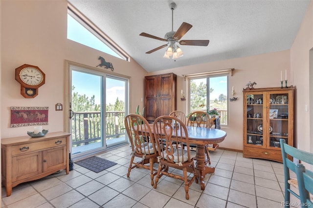 dining area with lofted ceiling, a textured ceiling, light tile patterned floors, and ceiling fan
