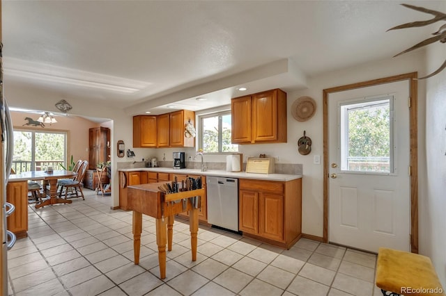 kitchen featuring stainless steel dishwasher, light countertops, healthy amount of natural light, and recessed lighting